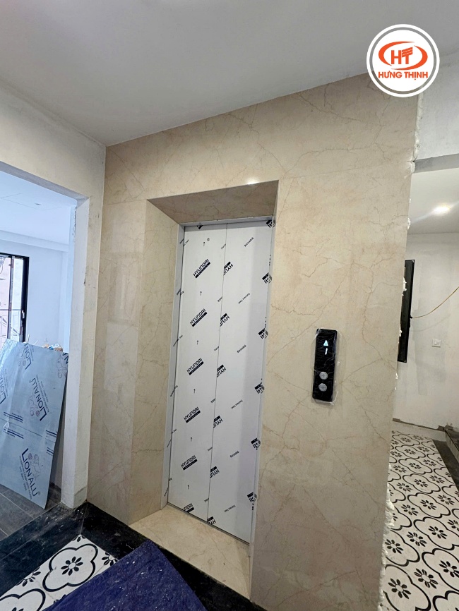 Hình ảnh mặt thang máy ốp đá Nung Kết Creama Marfil